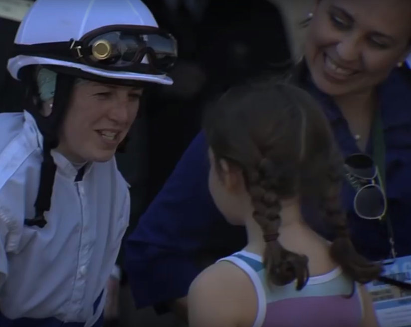 Jockey Sophie Doyle chats with a young fan.