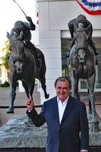 John Henry's trainer Ronald McAnally in front of the Against All Odds statue at Arlington Park (photo by Tom Ferry).